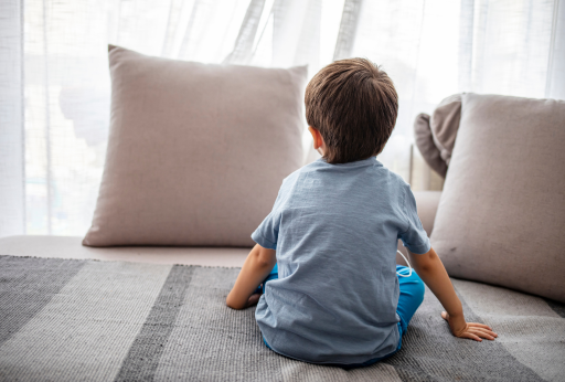 Tired autistic child looking out window