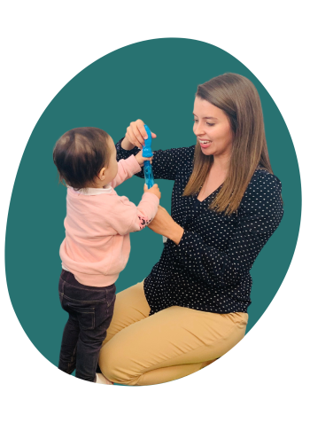 Anita Bennett-Stewart kneeling with child blowing bubbles